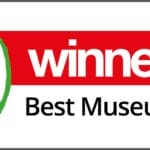 Logo for the School Travel Organiser Awards. A green apple sits on the left, with a red and white banner on the right.